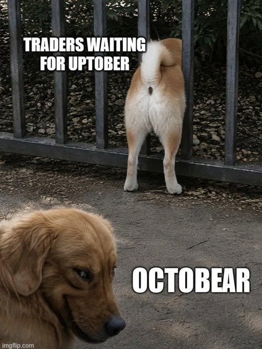 A meme showing one dog facing a fence labeled "TRADERS WAITING FOR UPTOBER" while another dog labeled "OCTOBEAR" approaches from behind, referencing the financial market slang for an expected bullish October versus a bearish October.