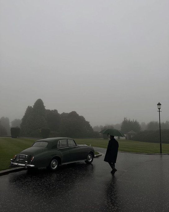 A solitary figure with a green umbrella walks past a vintage luxury car on a foggy, rain-slicked road, evoking a sense of mystery and old-world gravitas.

The image's moody, contemplative atmosphere mirrors the post's theme of looking beyond superficial "noise" to find substance—pairing an enigmatic, classic scene with a message about cutting through empty engagement to recognize meaningful value.