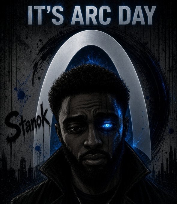 A stylized graphic reading "IT'S ARC DAY" with "Stanok" scrawled in graffiti-style text features a bearded man with one glowing blue eye set against a dark cityscape and a metallic arch—visually evoking the dramatic "Arc Day" announcement energy of the post. The design merges a heroic, superhero-like portrait with urban grit to celebrate the milestone moment.