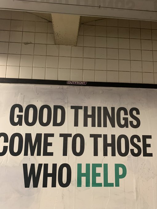 A banner mounted on a tiled wall reads 'GOOD THINGS COME TO THOSE WHO HELP' in bold black text with the word 'HELP' highlighted in green.