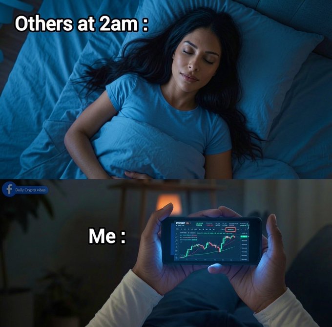 A two-panel meme contrasting a peacefully sleeping woman at 2am ("Others at 2am") with a person wide awake checking a green trending Bitcoin/crypto chart on their phone ("Me"), highlighting how crypto traders stay glued to price action instead of sleeping.