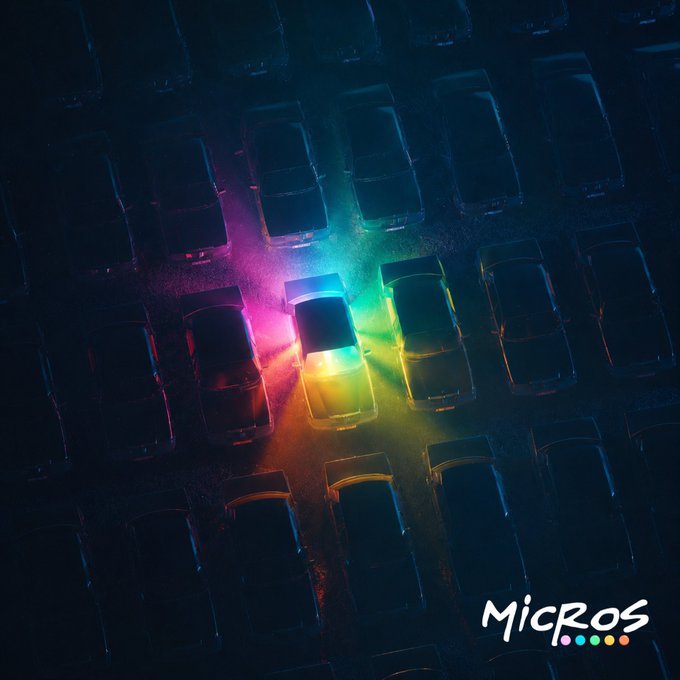 An aerial nighttime view of a parking lot where one car in the center is illuminated by vibrant rainbow-colored lights, with the 'MICROS' logo in the bottom right corner.