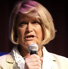 Senator Cynthi Lummis, with blonde hair, is speaking into a microphone during an interview on The Block about crypto legislation.