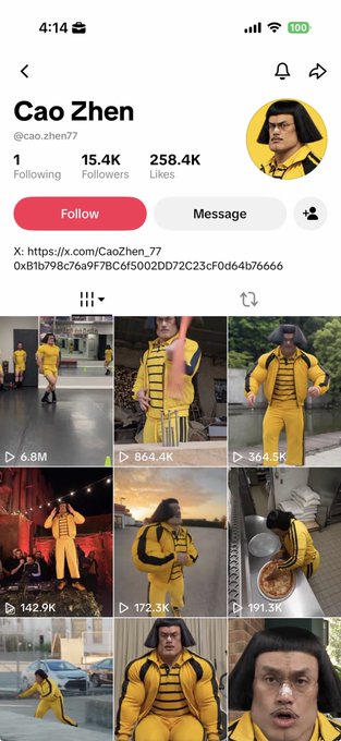 The image shows a TikTok profile page for "Cao Zhen" (@cao.zhen77), which has 15.4K followers, 258.4K likes, and a verified checkmark, featuring various videos of a man dressed in yellow tracksuit-like costumes resembling the villainous "Gangnam Style" Psy character. The post humorously suggests that Binance executives CZ and Yi He should check out their meme lookalike duo, as Cao Zhen appears to be styled after the iconic Psy persona.
