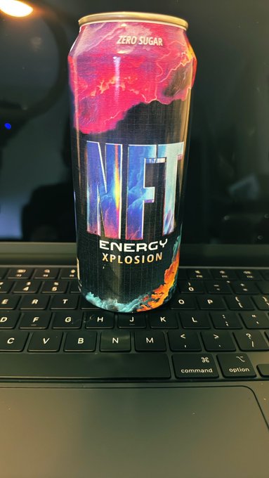 A can of 'JETF Energy Xplosion' zero sugar energy drink with a vibrant red, black, and blue design, sitting on a laptop keyboard.
