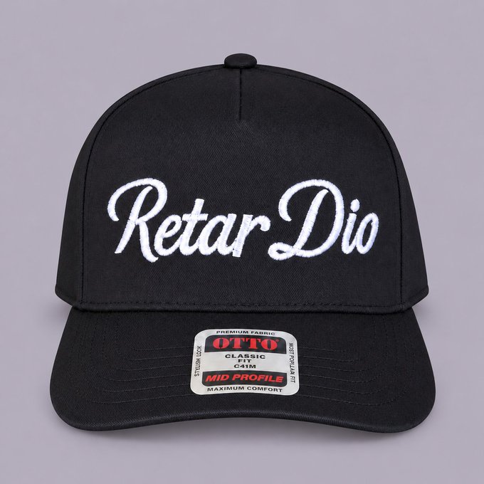 A black Otto brand mid-profile snapback cap featuring the text 'Retar Dio' embroidered in white cursive script across the front.