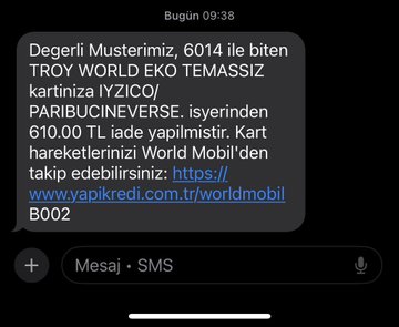 Turkish SMS message dated 09:38 from World Mobil informing a customer that their Troy World Eko card linked to phone number 6014 has been charged 610.00 TL by Paribucineverse, with a verification link to yapi kredi.com.tr.