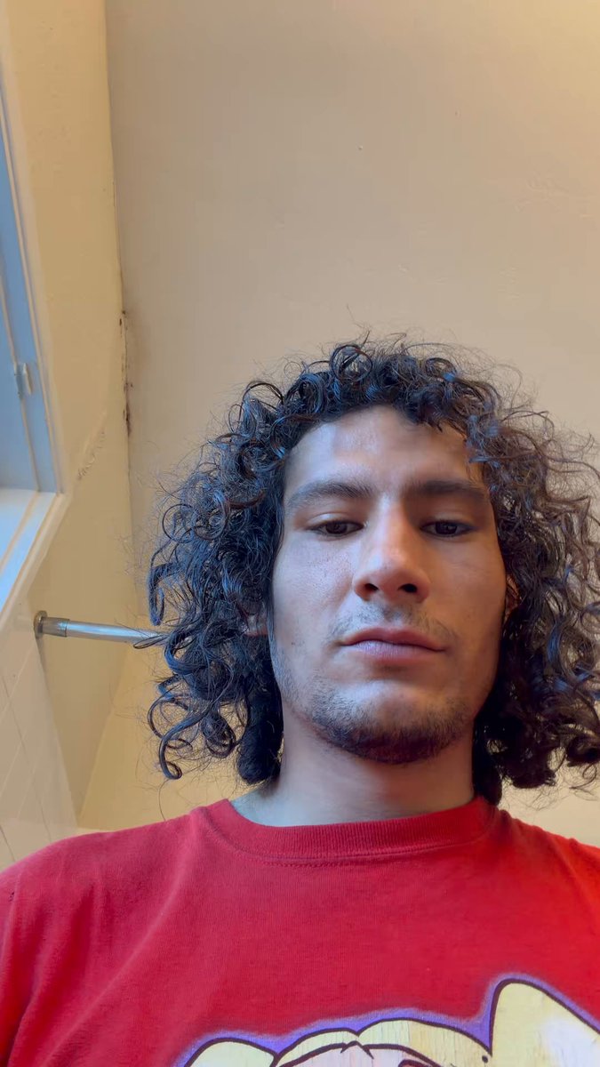 The image features a man with curly hair wearing a red shirt, looking at the camera while smiling. The caption below the photo reads "When $PUMP fun is deleted the world will be a better place. Their new app sums up the value of their ecosystem contributions:".