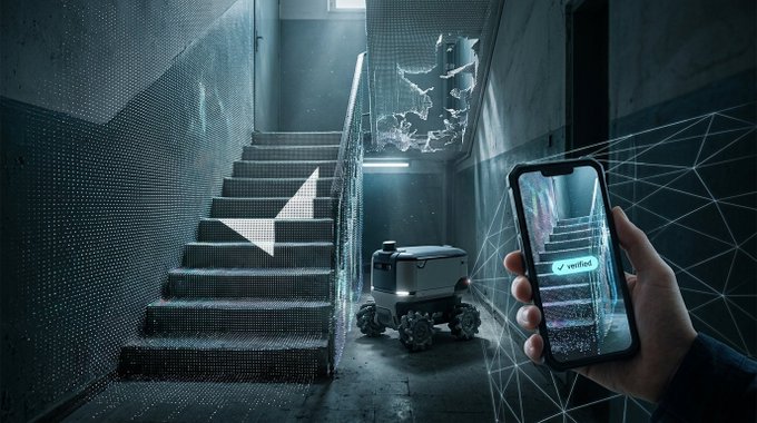A futuristic scene shows a small delivery robot navigating a dimly lit stairwell while a hand holds a smartphone displaying a live 3D scan of the stairs marked with a 'verified' checkmark.