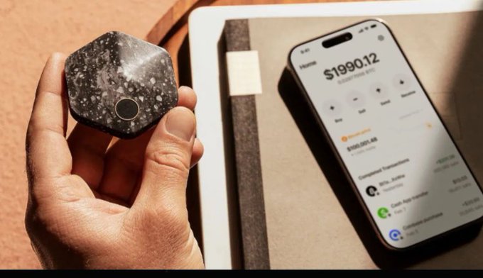 A hand holds a hexagonal Bitkey bitcoin hardware wallet beside an iPhone displaying a home balance of $1990.12, visually echoing the post's admiration of Block's (formerly Square) CEO Jack Dorsey's design — a "cube-like" geometric form now revealed as the polished, angular Bitkey device, with the ticker $XYZ noted in the caption.
