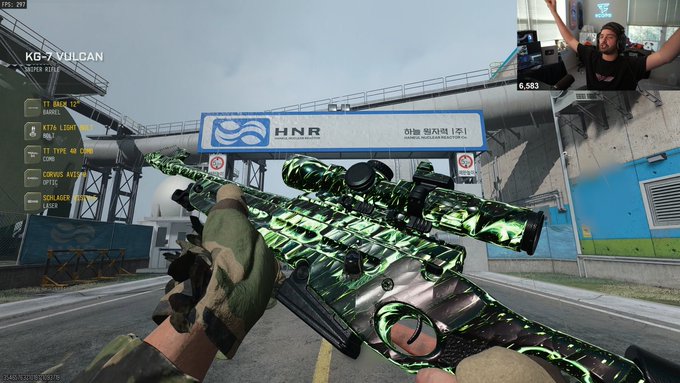 A first-person shooter player holds a green-and-black scoped sniper rifle in an industrial airport area marked “HNR.” The weapon HUD labels it “KG-7 VULCAN,” with “Master Prestige Vulcan” indicating a highly upgraded or prestigious variant, while a streamer appears in a facecam at the top right.