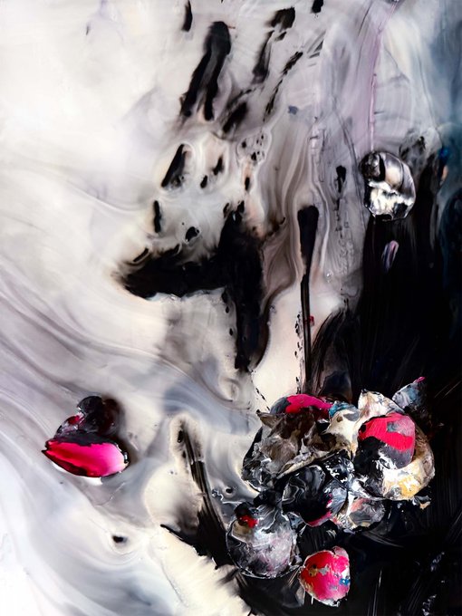 An abstract, swirling image with black, white, and grey fluid patterns surrounding dark shapes accented with bright pink and red spots.