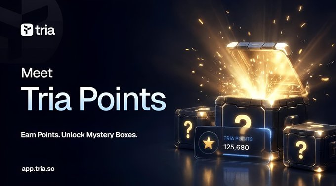 The image features a large golden box with a question mark inside of it, surrounded by small cubes. The text "Meet Tria Points" is displayed above the box, indicating that this is an advertisement for Tria Points. The background of the image is dark blue, and there are three cubes in total, each containing a question mark.