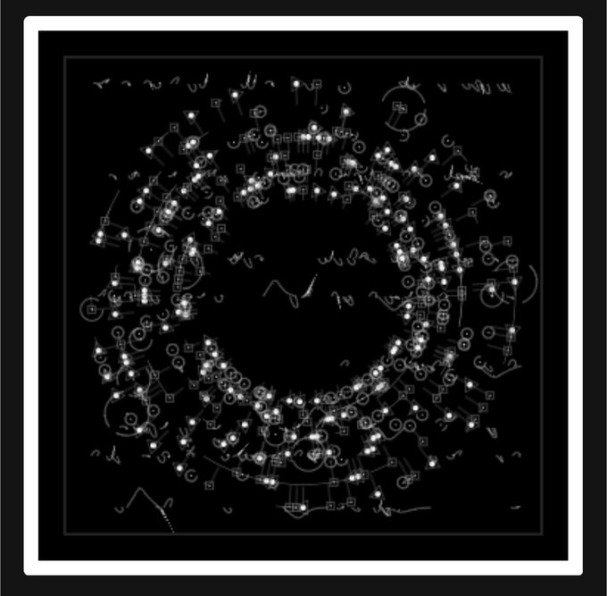 An abstract black-and-white image featuring a dense, circular arrangement of glowing dots, squiggles, and symbols forming a ring-like pattern on a black background.