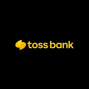 The image features a logo for a company called Toss Bank, which is located in South Korea. The logo consists of a yellow circle with a black outline, accompanied by the words "Toss Bank" written below it. There are also some text elements present on the image that read "LATEST: South Korea's Toss Bank has signed an MOU with the @SolanaFndn to test blockchain-powered cross-border payments and stablecoin settlements." This information suggests that the company is actively involved in testing and developing new payment solutions using blockchain technology.