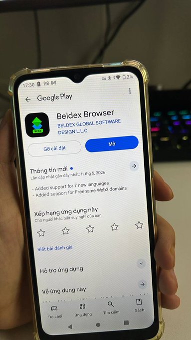 A hand holds a smartphone displaying the Google Play Store page for "Beldex Browser" by Beldex Global Software Design L.L.C., featuring a "Mở" (Open) button indicating it's already installed. The screenshot supports the user's post about testing the Beldex Browser, showing the app's listing on their Jambo phone.