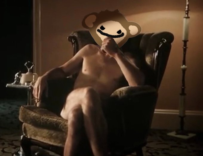 This image shows a person with a monkey emoji superimposed over their face, sitting in an armchair with a lamp in the background. The image directly relates to the post "BJ Pups, take a seat and let it all out," suggesting a moment of vulnerability or catharsis.