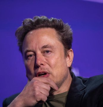 A man rests his chin on his hand in a contemplative pose against a purple backdrop. The image likely accompanies the post about Tesla's financial struggles, as he is the CEO of Tesla, the company that reported a $112 million loss on its Bitcoin holdings and negative free cash flow.