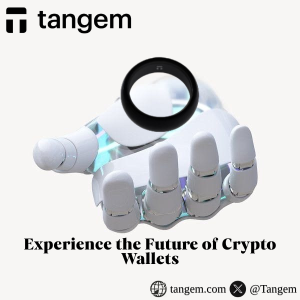 A Tangem crypto wallet advertisement displays a futuristic robotic hand holding a black ring-shaped NFC wallet, with the tagline 'Experience the Future of Crypto Wallets' and social media handles.
