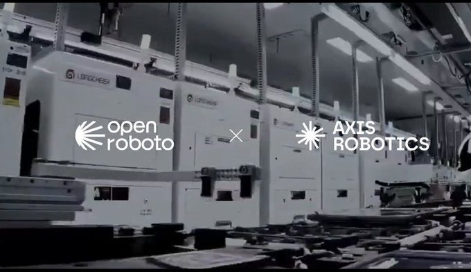 The image shows an industrial robotics facility featuring multiple white automated machines branded "LOGAESZ" with the "open roboto" and "AXIS ROBOTICS" logos displayed side by side. This visually represents the newly announced strategic partnership between OpenRoboto and Axis Robotics, illustrating the integration of advanced robotics manufacturing with decentralized AI infrastructure on Bittensor's Subnet 80.
