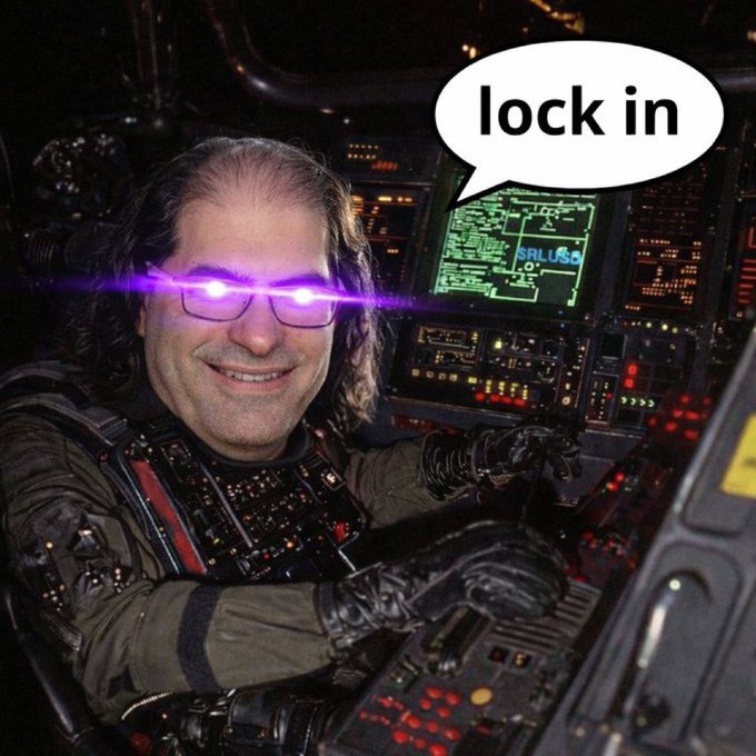 A humorous edited photo of a man smiling while piloting a spacecraft cockpit, with glowing purple laser eyes added and a speech bubble saying 'lock in'.