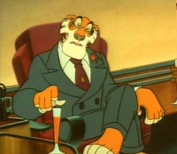 An animated tiger character in a gray suit and red tie sits in a red armchair, looking stern while a champagne glass rests nearby.