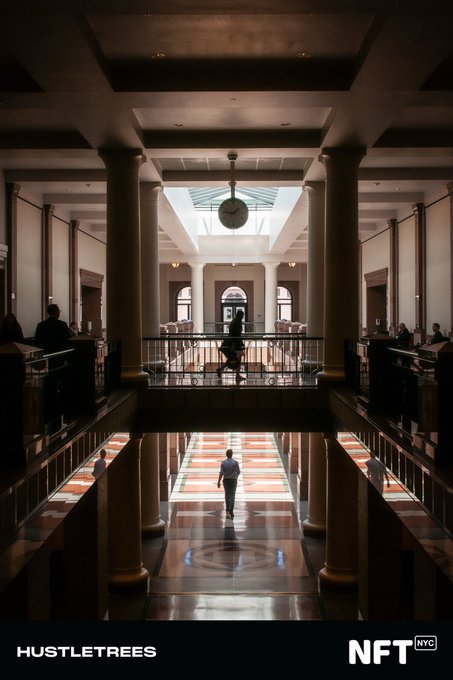 A symmetrical interior shot of a grand hall with tall columns, a hanging clock, and a person walking across a polished floor, branded with 'HUSTLE TREES' and 'NFT NYC'.