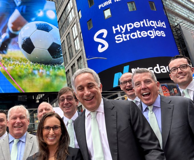 A group of smiling professionals in suits pose beneath a Nasdaq billboard displaying the "Hyperliquid Strategies" logo, celebrating the company's public listing alongside context about its accumulation of 38.7 million $HYPE tokens. The image ties to the upcoming interview with CEO David Schamis by capturing the celebratory moment of Hyperliquid Strategies' market debut.