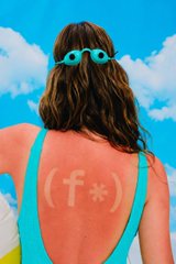 A woman in a teal bikini top stands with her back to the camera against a blue sky, displaying a sunburn on her shoulders with "(f*)" written on it—a playful pun playing on "SPF" (sun protection factor). The image cleverly visualizes the post's metaphor about Fhenix's Fully Homomorphic Encryption (FHE) technology providing "SPF" (data protection) for onchain information.