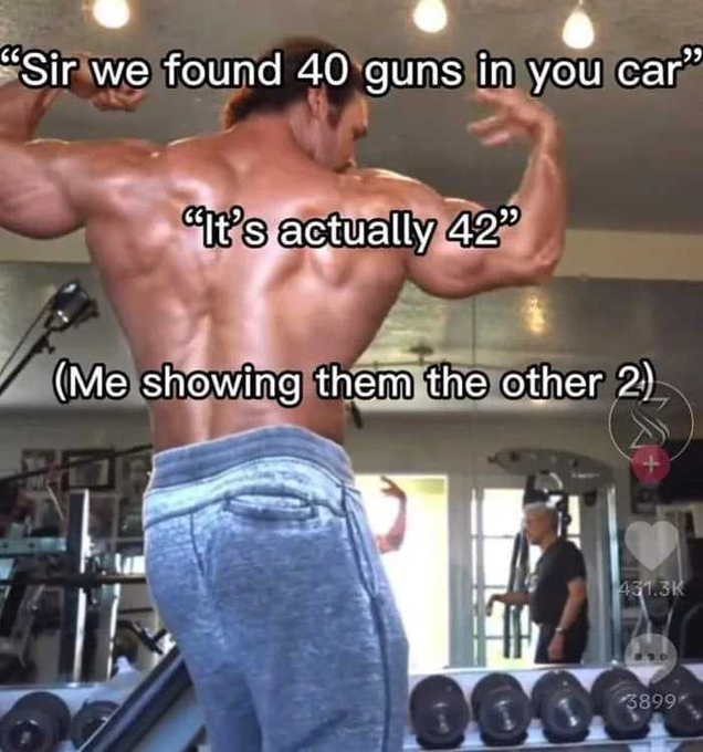 A screenshot from a social media video shows a muscular man in a gym flexing his back muscles while flexing, with overlaid text reading "Sir we found 40 guns in you car," "It's actually 42," and "(Me showing them the other 2)," with 431.3K likes and 3899 comments visible. The image relates to "GM Mfers" as it's a popular gym motivation meme often shared in fitness and hustle-culture communities.