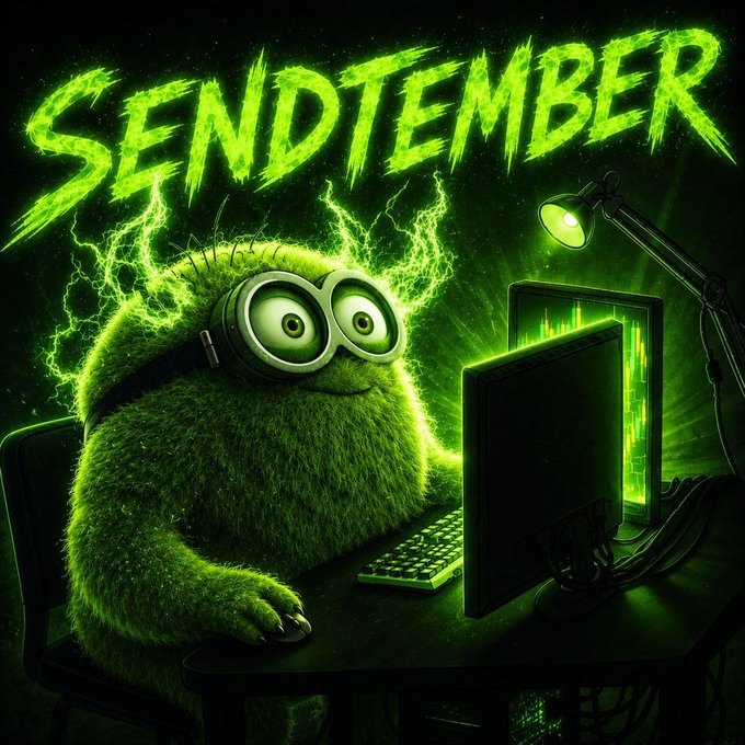 A green, furry creature with goggles sitting at a computer desk with the text 'SENDTEMBER' displayed prominently above.