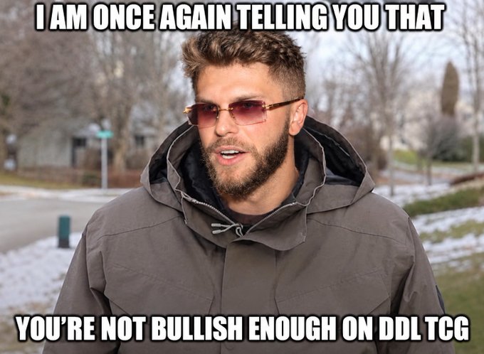 A man in a winter coat and sunglasses with text reading 'I AM ONCE AGAIN TELLING YOU THAT' at the top and 'YOU'RE NOT BULLISH ENOUGH ON DDL TCG' at the bottom.