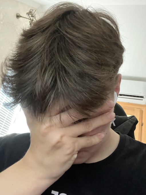 A person in a black shirt covers their face with their hand while showing off their messy brown hair from a low angle, captured in what appears to be a selfie, complementing the post's humorous "tired of winning" sentiment on day 91 of the $PENGU posting challenge with a +3% daily price change.