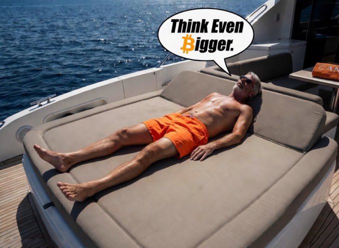 A meme image showing Michael Saylor lying shirtless on a yacht sunbed with a speech bubble reading 'Think Even Bigger.' with the Bitcoin '₿' symbol replacing the 'B'.