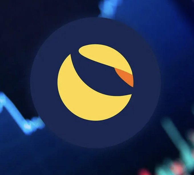 The LUNA (Terra) cryptocurrency logo displayed as a yellow and orange circular emblem against a dark blue background with faint financial chart lines.