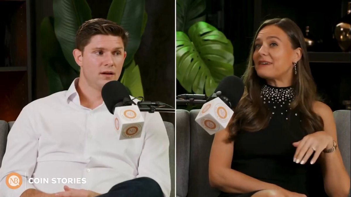 The image shows two people sitting next to each other with microphones, likely participating in an interview or discussion about Bitcoin. The person on the left side of the image has a microphone, while the person on the right side also has one. Both individuals are wearing black outfits and appear to be engaged in conversation.