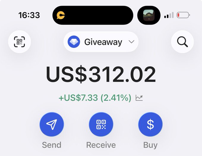 A screenshot of a cryptocurrency wallet app showing a "Giveaway" account balance of US$312.02 with a gain of +US$7.33 (2.41%), featuring Send, Receive, and Buy options—relating to the post about an ongoing giveaway for active participants.