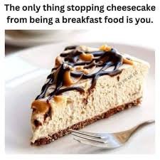 A meme with the text 'The only thing stopping cheesecake from being a breakfast food is you.' above an image of a peanut butter chocolate swirl cheesecake slice on a plate with a fork.