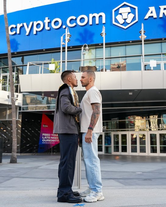 Two UFC fighters face off nose-to-nose during a promotional stare-down outside the Crypto.com Arena, with the venue's "crypto.com" signage prominently displayed above them. The image ties to the UFC 331 face-off announcement between Joshua Van and Pantoja, scheduled to broadcast live on Paramount+ on September 19 at 9pm ET.