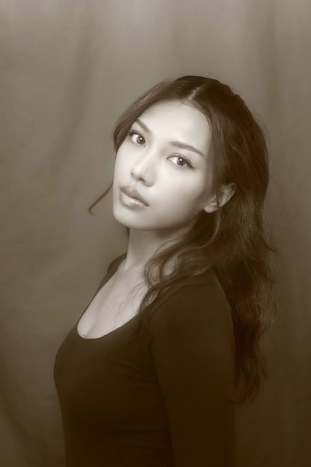 A sepia-toned portrait shows a young woman with long dark wavy hair and a black top, gazing softly at the camera against a muted, painterly background. The image pairs with a personal reintroduction post where the author shares their background in crypto, work at TradeOnFortuna, and current project building, using the portrait to put a face to their online persona "Morph."