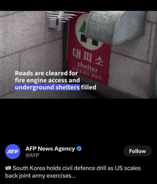 A tweet screenshot from AFP News Agency showing a red 'Shelter' sign in Korean with English caption text reading 'Roads are cleared for fire engine access and underground shelters filled,' related to South Korea's civil defense drill.