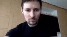 The image features a man with a beard wearing a black shirt, looking directly at the camera while holding up his phone. The caption of the image reads "*Durov seeing my fragment account bidding gram related usernames before he announced the rebrand to gram*". This suggests that the man might be sharing some information or content on social media platforms with his followers.

The post seems to be about a TV show, as it is titled "Who's this guy?". The image also includes a reference to the TV series "Durov", which could indicate that the man is discussing or promoting the show among his online audience.