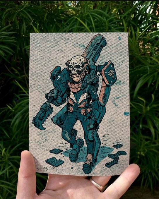 A hand holds up a small canvas artwork depicting a heavily armed cyborg character with a skull head and skull-themed armor, signed 'designed by LHQ'.
