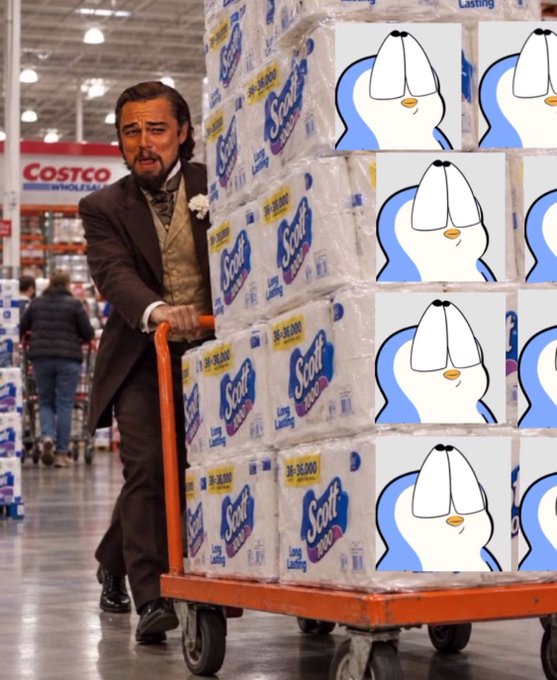 Leonardo DiCaprio from The Great Gatsby pushing a Costco cart loaded with Scott paper towel packages, which have been edited with a smug penguin face meme overlay.