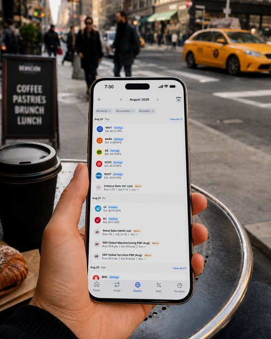 A hand holding a smartphone displaying an economic events calendar for August 2026, with a blurred New York City street scene and yellow taxi in the background.