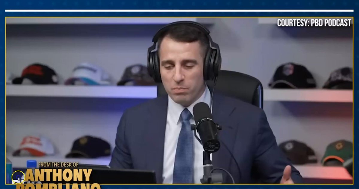 The image features an interview with Anthony Pompiano, who is wearing headphones while sitting at his desk. He is talking about his personal Bitcoin strategy, which includes not selling any Bitcoins he has bought. This statement emphasizes that he does not feel the need to sell his Bitcoins and trusts in their value.