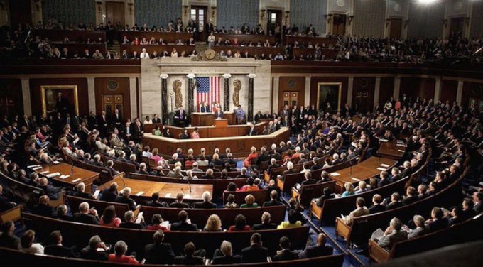 A wide view of the United States House of Representatives chamber filled with members of Congress during a joint session, with an American flag displayed at the front.
