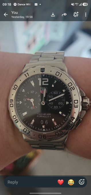 A person's wrist sports a silver TAG Heuer Formula 1 chronograph watch with a black dial, shown in a screenshot of a social media post.