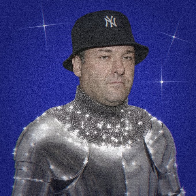 A man with a serious expression wears a New York Yankees bucket hat atop medieval knight's armor, set against a sparkly deep blue background, visually embodying the "$KNIGHT" meme of a stoic, armored defender of masculine ideals contrasted against the clown-like image of typical crypto influencers.