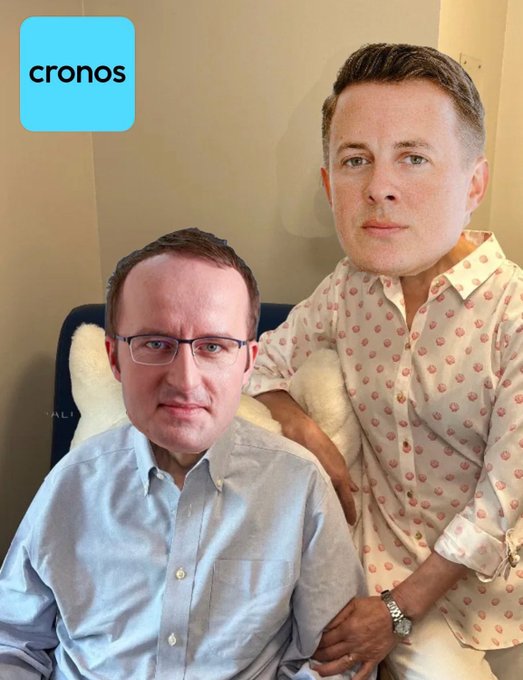 Two men sit together indoors; a blue logo with the text "cronos" appears in the top left corner.